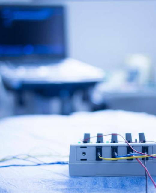 Dry needling electroacupunture machine connected to needles used by acupunturist on patient in pain and injury acupunture with electrical pulse treatment. No model releases or property releases required as no recognisable people and generic objects and place.